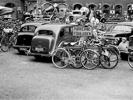 Cyklar uppställda bland bilar framför Konserthuset. 
