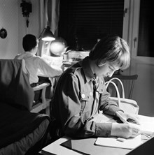 Ingvor Lindgren och Mats Lindgren gör sina hemläxor vid varsitt skrivbord. Oppundavägen 6