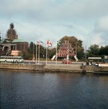 Strömgatan och Jakobs kyrka från Strömbron. Kyrkan är omgiven av byggnadsställningar. Brittiska flaggor på Karl XII:s Torg gör reklam för Brittiska veckan. Närmast en sightseeing-firma
