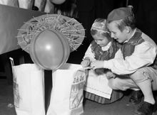 Hantverkargatan 1, Blå hallen i Stadshuset. Sällskapet jultomtarnes traditionella julfest för Stockholms barn. Syskonen Ulf och Meith Öberg tittar i julklappspåsen