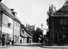 Torkel Knutssonsgatan 29-31 söderut från Hornsgatan. Huset t.h. ligger vid Hornsgatan 51 och står här inför rivning. T.v. går en kvinna med paraply. Pantbank står det på husväggen