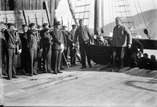 Kvarlevorna efter deltagarna i Andrées polarexpedition år 1897, Salomon August Andrée, och Nils Strindberg, bärs i land  från Bratvaag i Tromsö hamn i Norge.