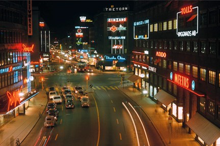 Vy över Kungsgatan med neonskyltar.