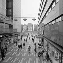 Sergelgatan söderut vid varuhusen Kvickly och EPA. Brandgavlar med reklam i fonden i kv. Fyrmörsaren, blivande kv. Skansen med Kulturhuset.