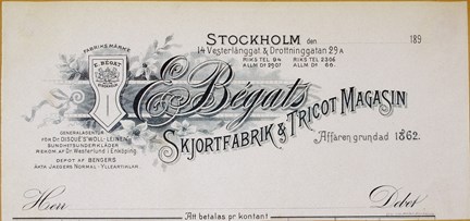 Brevhuvud tryckt i svart med dekorationer och text.